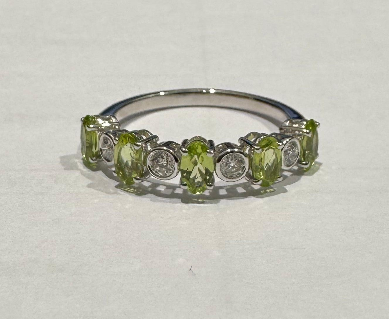 0.21 ct oval cut color stone and diamond 18k white gold ring