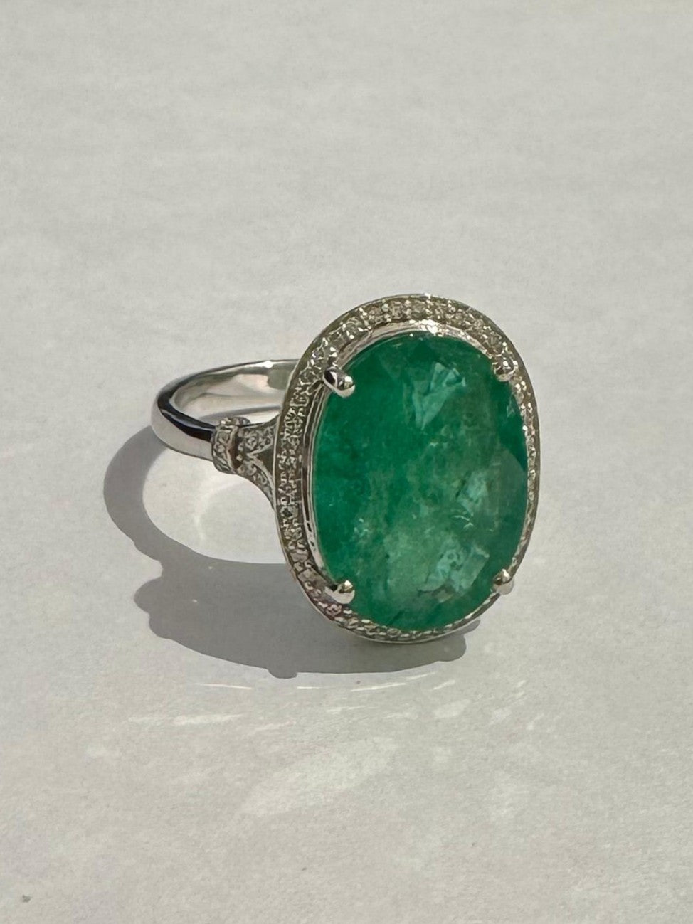 0.28 ct oval cut emerald and diamond 18k white gold ring