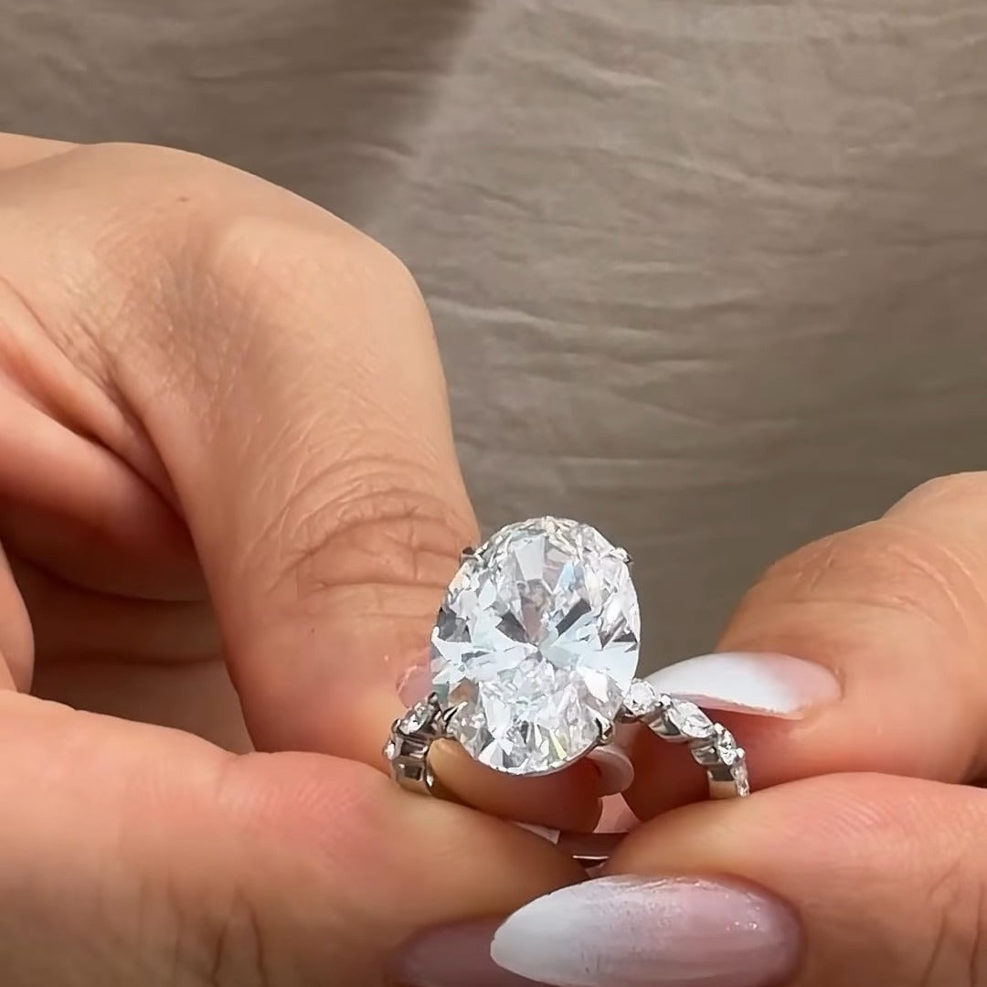 Custom oval diamond engagement ring with marquise and round diamond band by BYORO Dubai